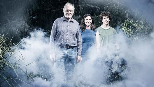 Ross Bradstock, Christine Eriksen and Alan Green, the bushfire research team walk through a smoky scene