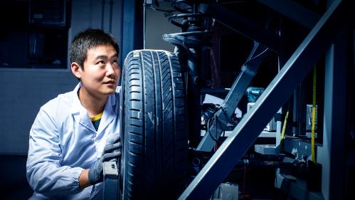 Shuai Shuai Sun MR technology researchers looks at the underboady of a vehicle