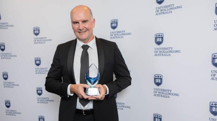 Darren Saunders at the awards holding his trophy.