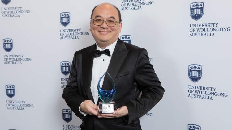 Distinguish Professor Willy Susilo at the awards holding his trophy.