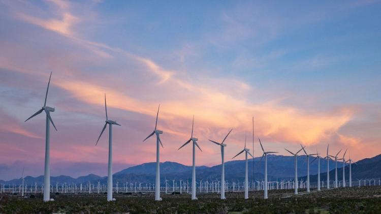 Wind turbines, sunset in background