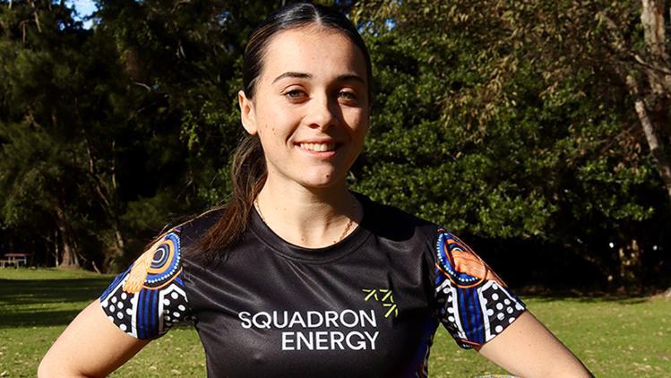 Indigenous Nationals UOW team member wearing team uniform with  Squadron Energy Sponsorship