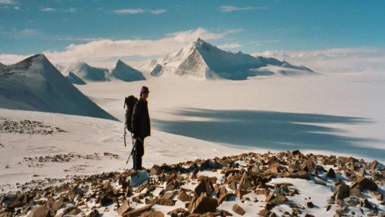 Person trekking in the snow on a sunny day