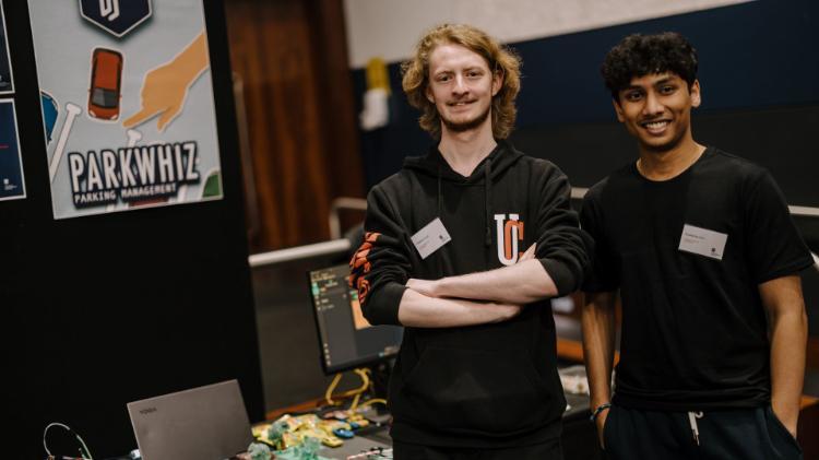 Two students proudly stand alongside their innovative product at the 2023 SECTE innovation fair