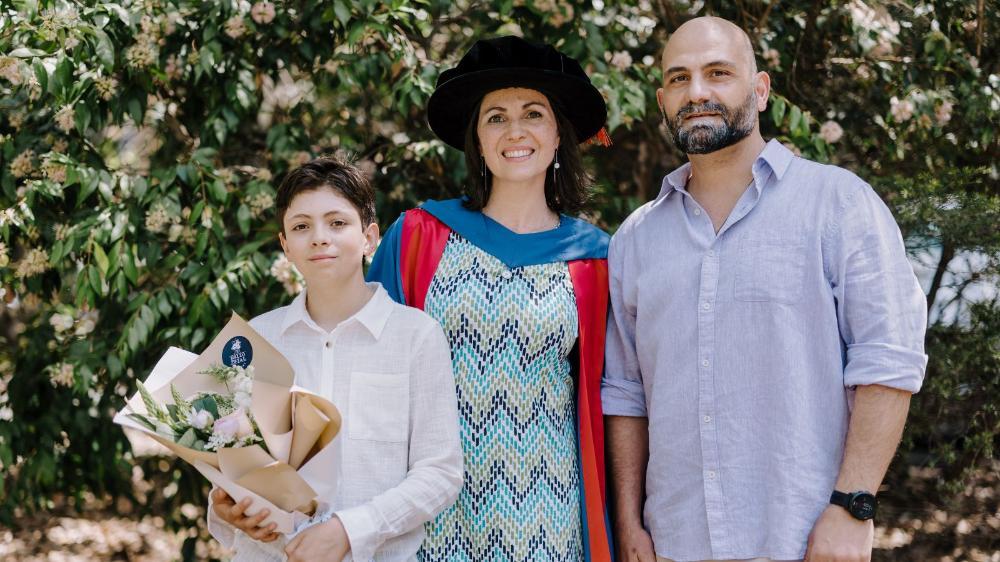 Dr Lilian Ariztimuno and family smiling at the camera at graduation, October 2024