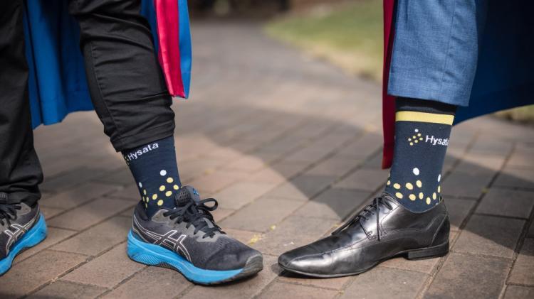 Dr Anh Linh Hoang and Dr Aaron Hodges show off their black Hysata branded socks. Photo: Michael Gray