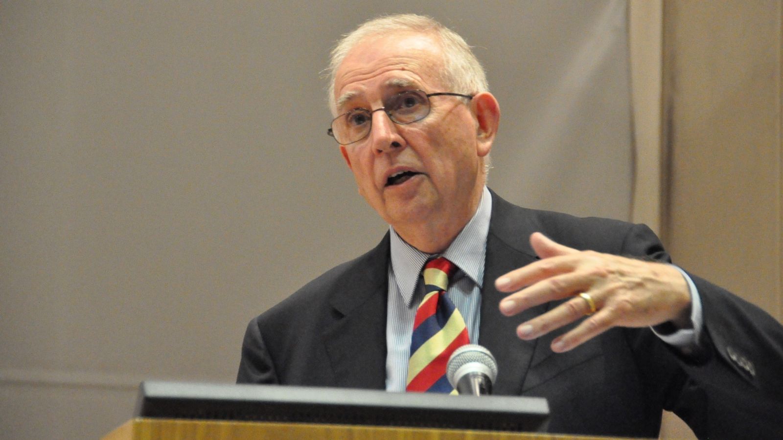 Dr Hugh Mackay speaking during a presentation at a lectern. Photo supplied by Hugh Mackay.