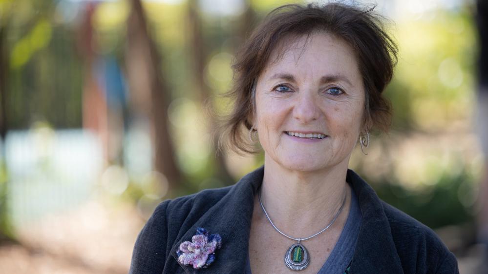 Dr Shoshana Dreyfus is close up with the playground in the background. Photo: Mark Newsham