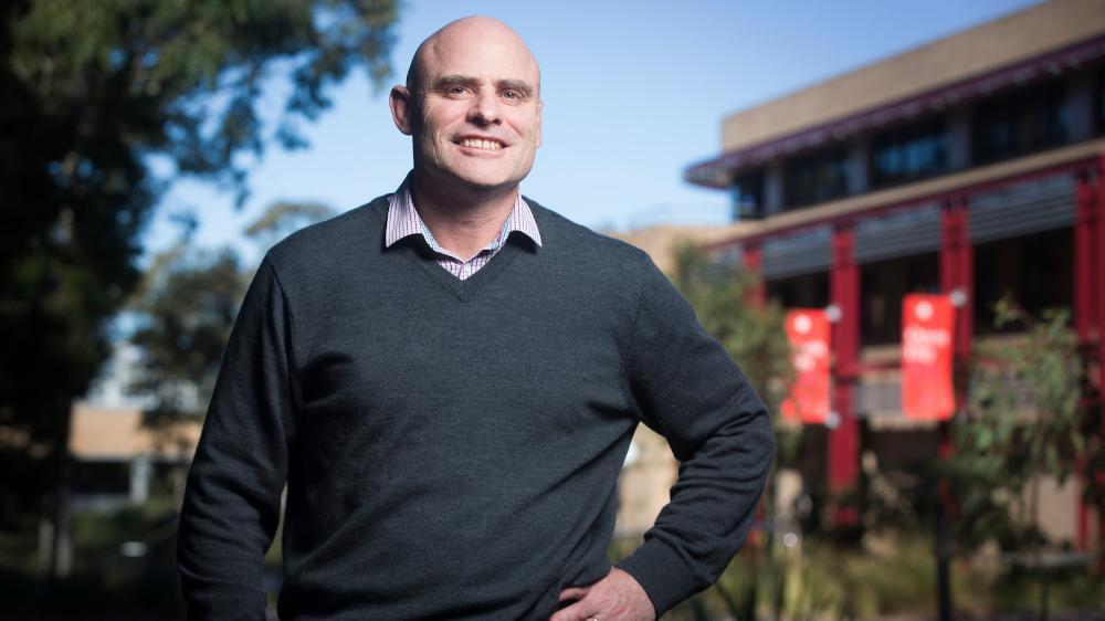 Tony Okley stands in front of the Early Start Building. Photo: UOW