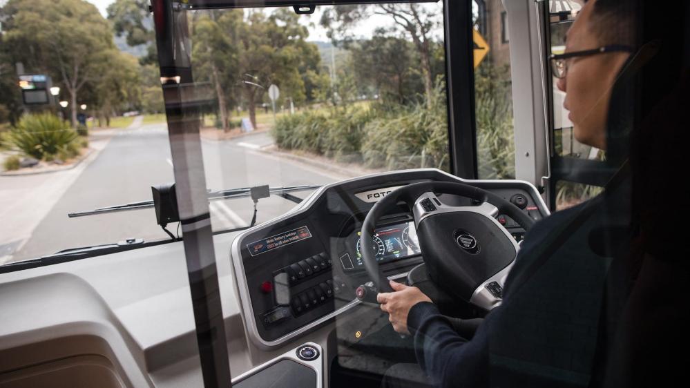The driver of the UOW electric bus with the bus's electric dashboard in the background. Photo: Michael Gray